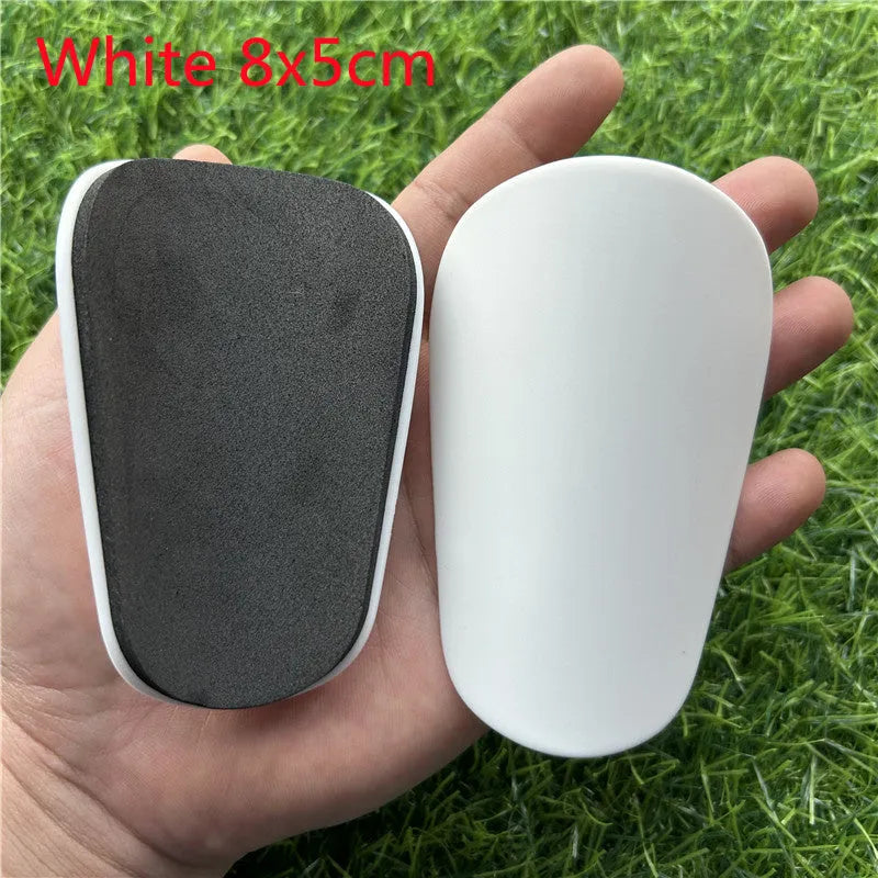 Extra small mini plastic football shin guards in black and white 8x5cm sizes