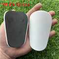Extra small mini plastic football shin guards in black and white 8x5cm sizes