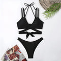 Women's solid colour strap bikini swimsuit in briefs style showing black, blue, red, rose red, and white colour options