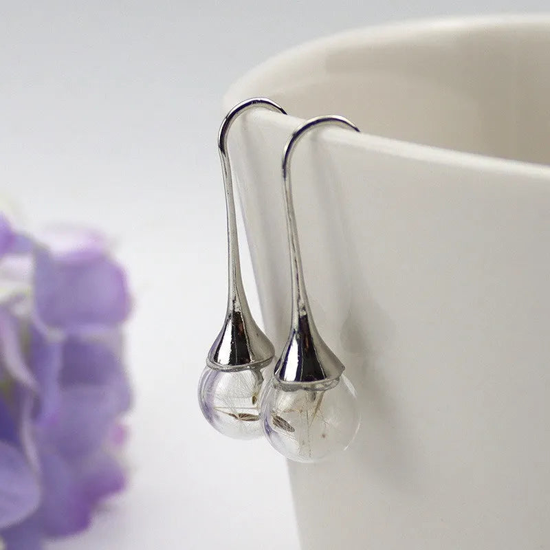 Transparent 16mm glass ball earrings with crystal dandelion seed design on silver French hooks