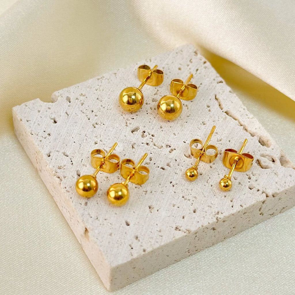 Stainless steel ball stud earrings in gold and silver colours showing 3mm to 6mm size range