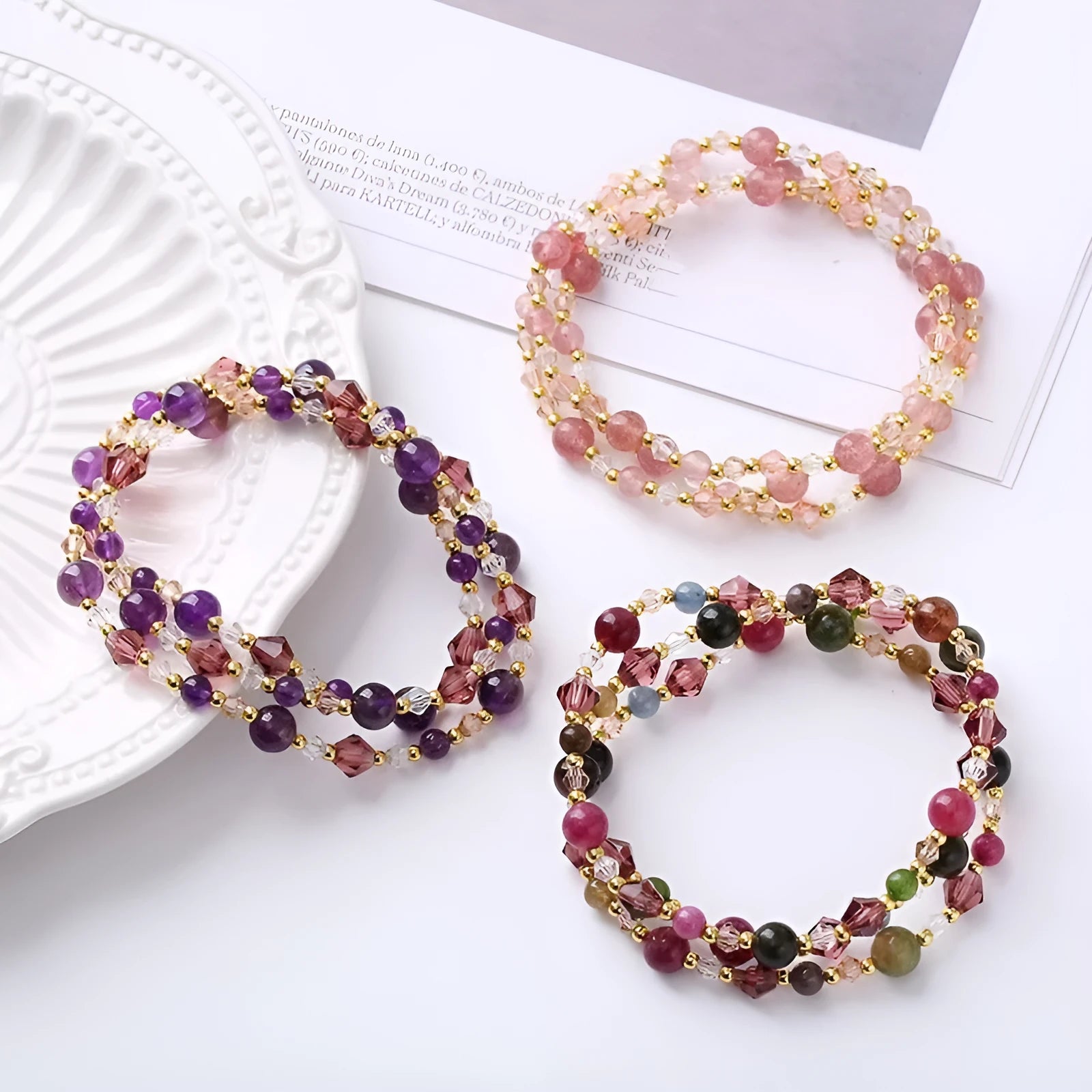 Adjustable bracelet with tourmaline, strawberry quartz, and amethyst crystals in a three-ring design.