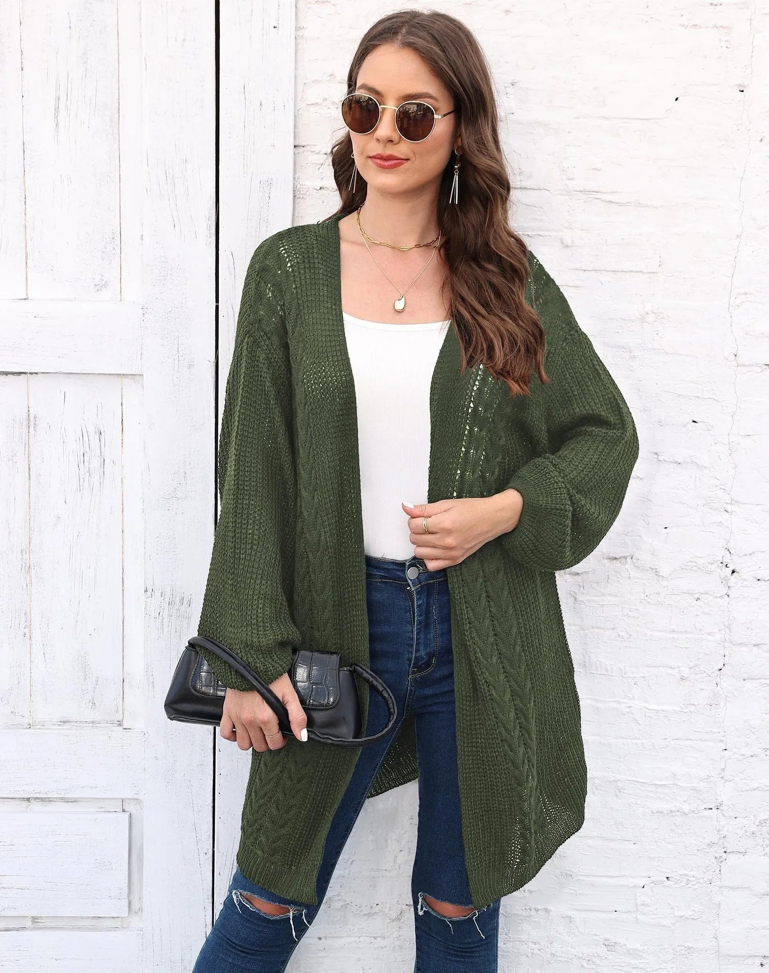 Women's loose acrylic sweater coat in army green, shown as a layering piece.