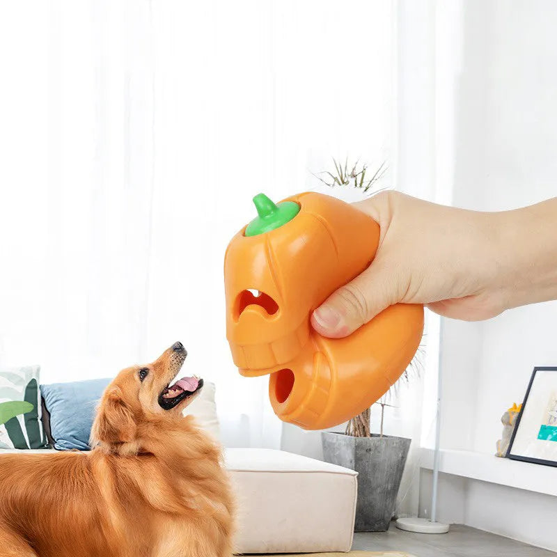 Halloween pumpkin shaped orange interactive dog chew toy with treat-dispensing funnel