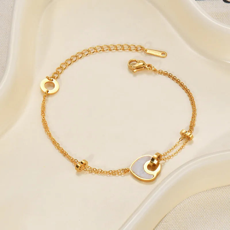 Ins style stainless steel and resin bracelet with a double-layered heart charm.