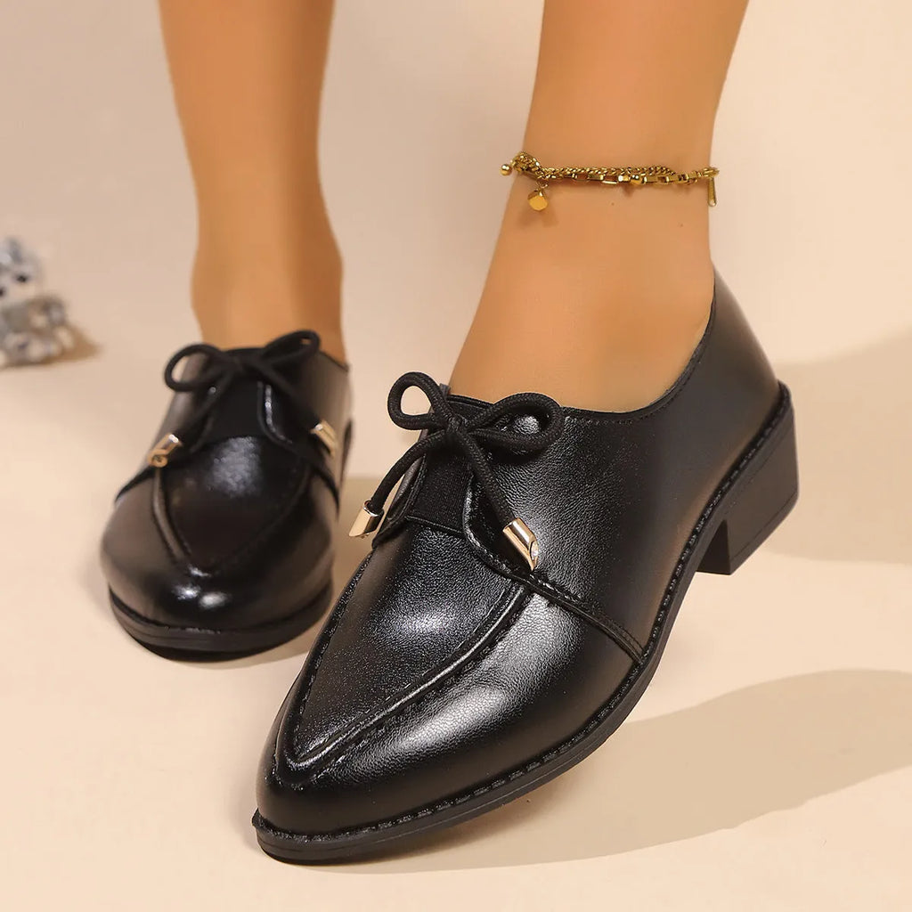 Women's British-style leather shoes with decorative bow detailing on pointed toe