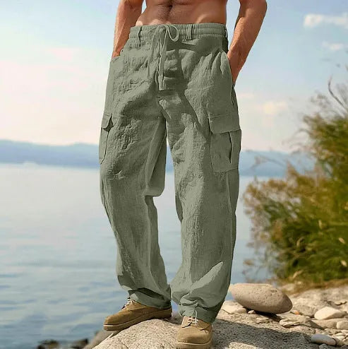 Man wearing light army green loose cotton wide-leg casual trousers with a mid waist.
