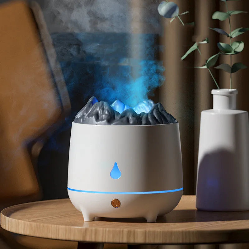 Black and white volcano-shaped ultrasonic humidifier with USB cable on a desk.
