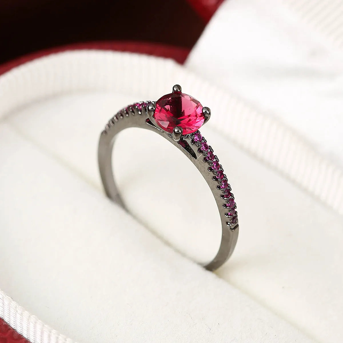 Geometric hexagon copper ring with colourful zircon stones in a metallic electroplated finish.
