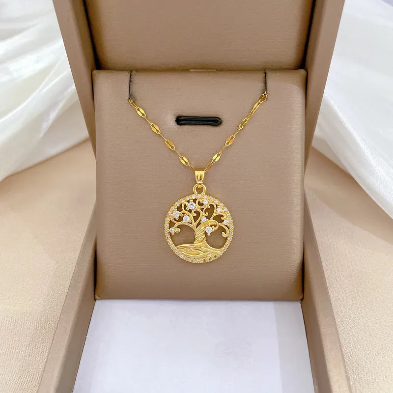Gold-plated cross necklace with mother-of-pearl lucky tree pendant and rhinestone detailing on adjustable lip chain