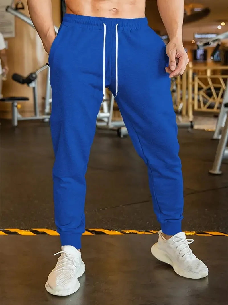 Men's polyester leisure trousers with elastic lace closure and drawstring waist in loose fit design