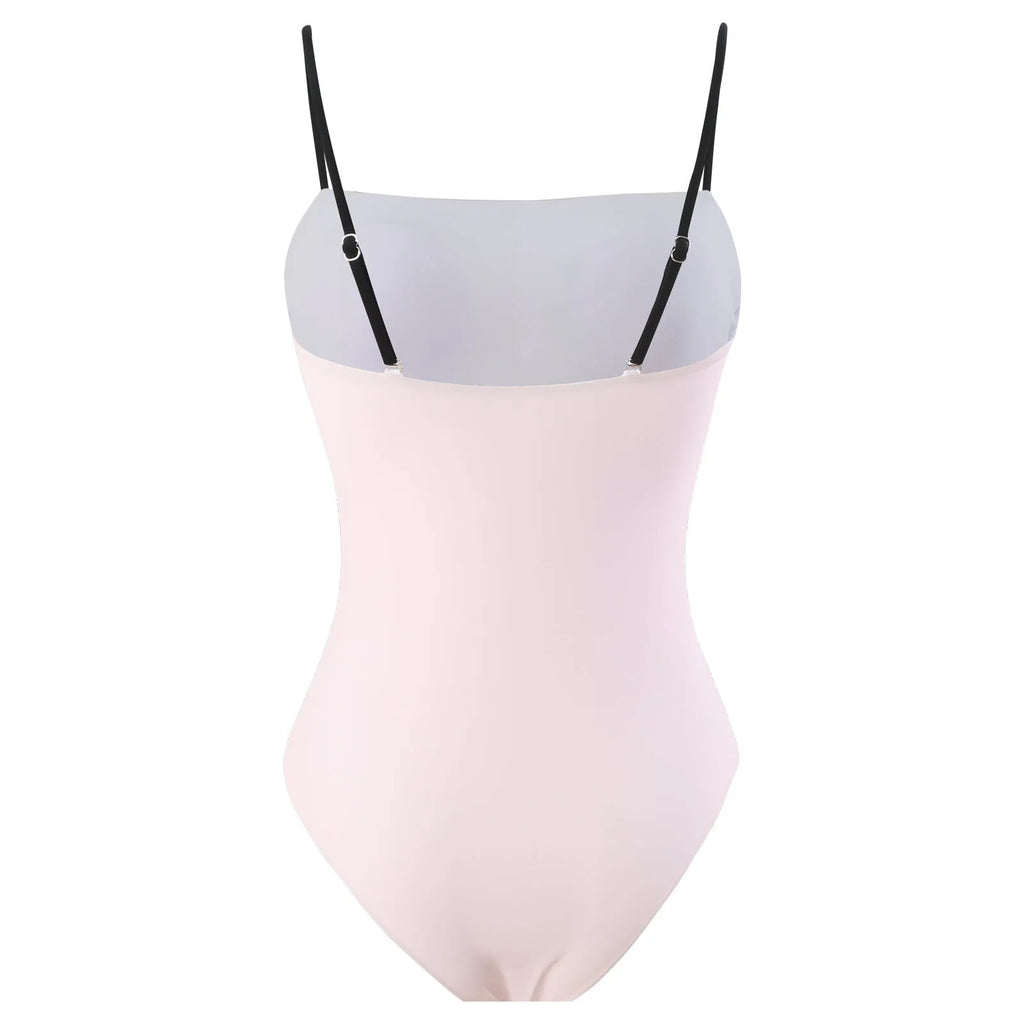 Women's patterned bikini top and bottoms with a matching light blue tulle skirt laid flat.