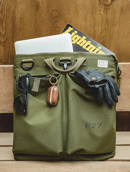 Marden Tooling military green canvas messenger bag with crossbody strap on a table