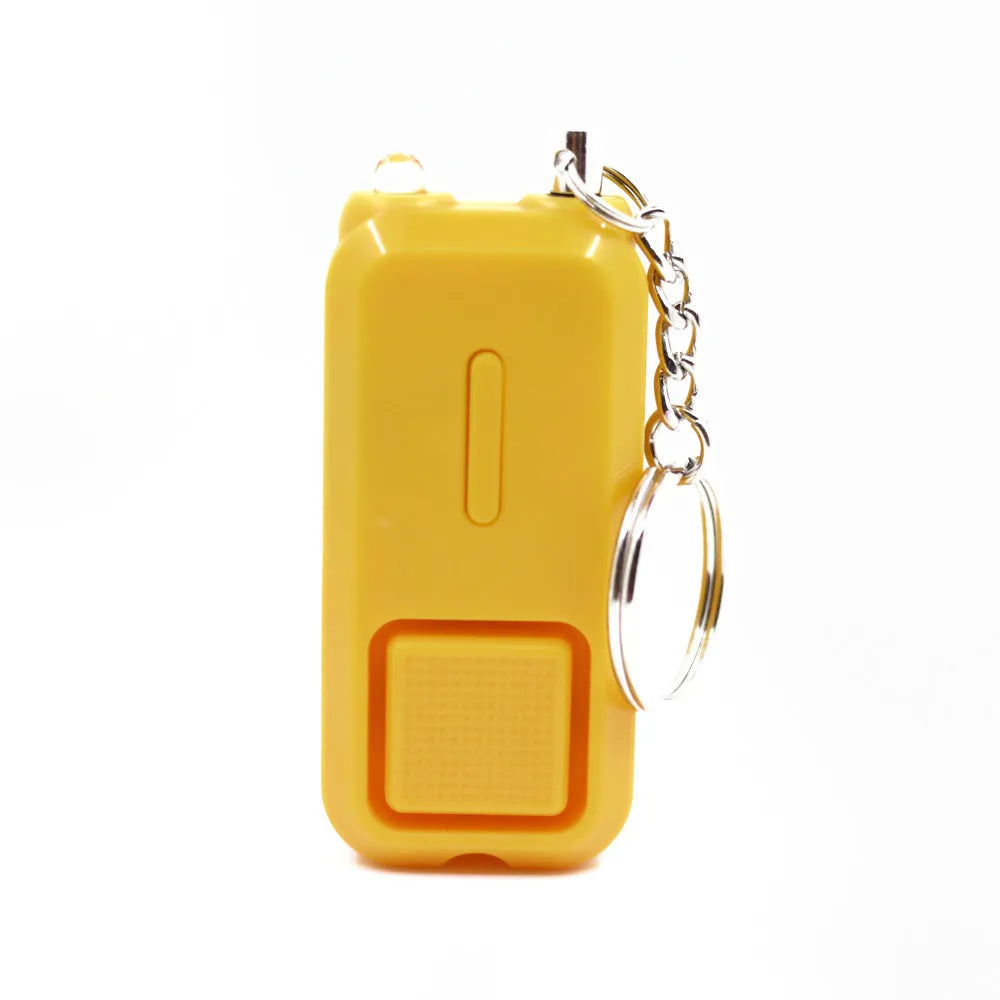 Compact pink personal safety alarm with keyring, showing dimensions next to a ruler.