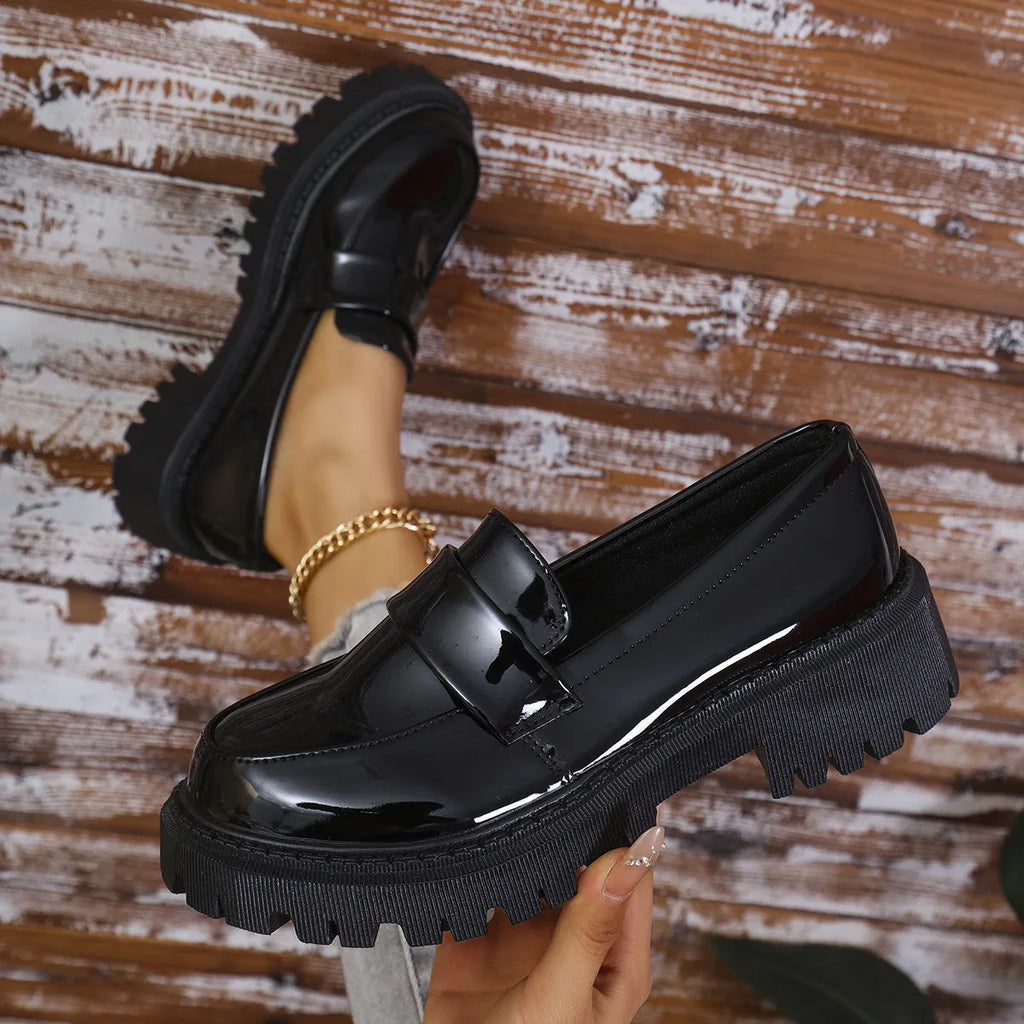 Plus size women's slip-on loafers in black with a chunky platform heel and rubber sole.