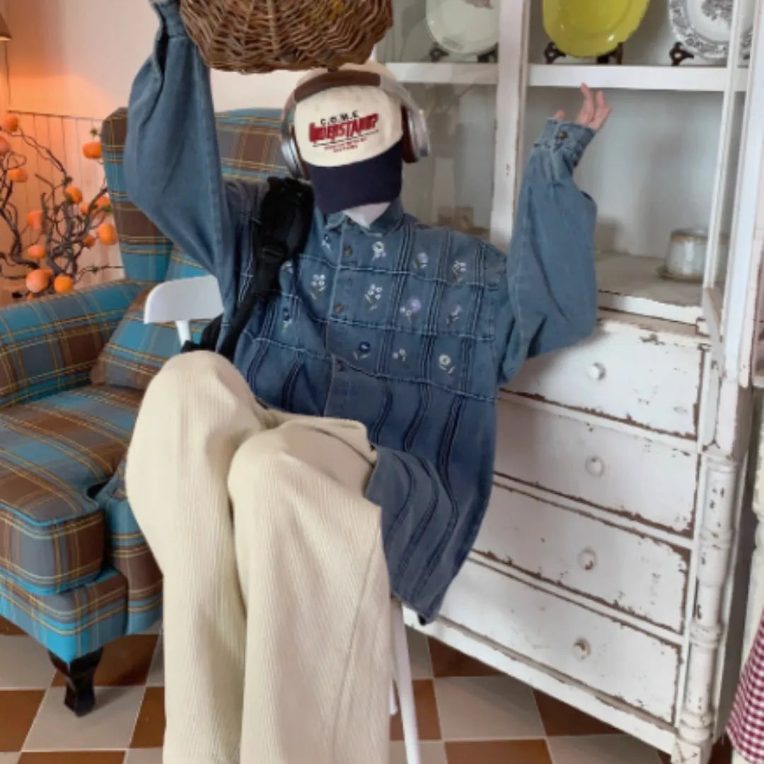 Vintage washed blue denim shirt with small floral print and pleated detailing on long sleeves