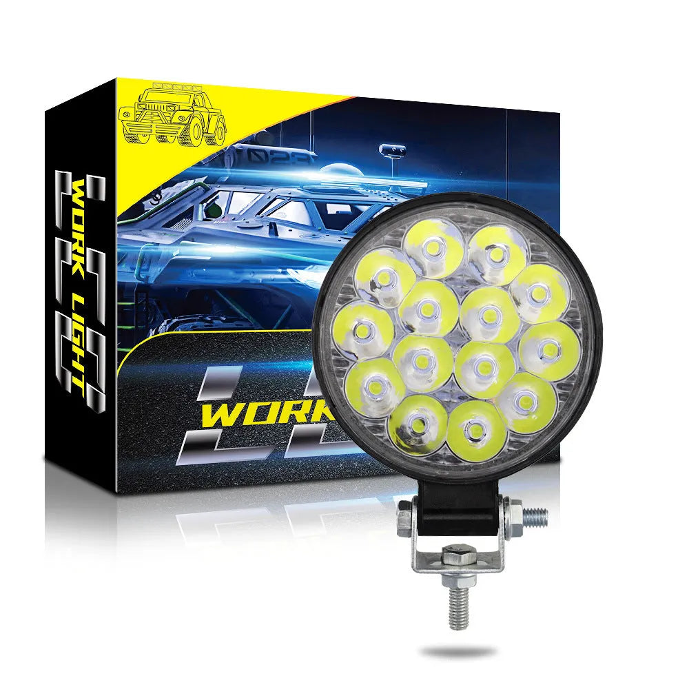 Compact round aluminium LED work light for cars and off-road vehicles with white light output.