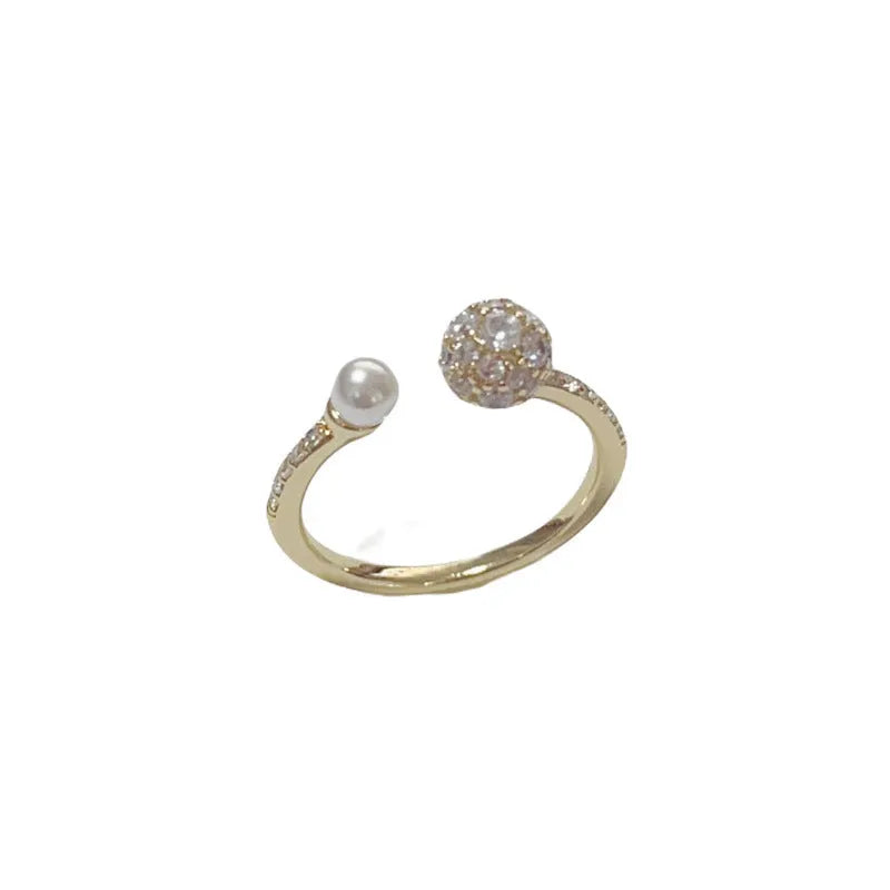 Gold plated open-end ring with round zircon pearl element on copper base