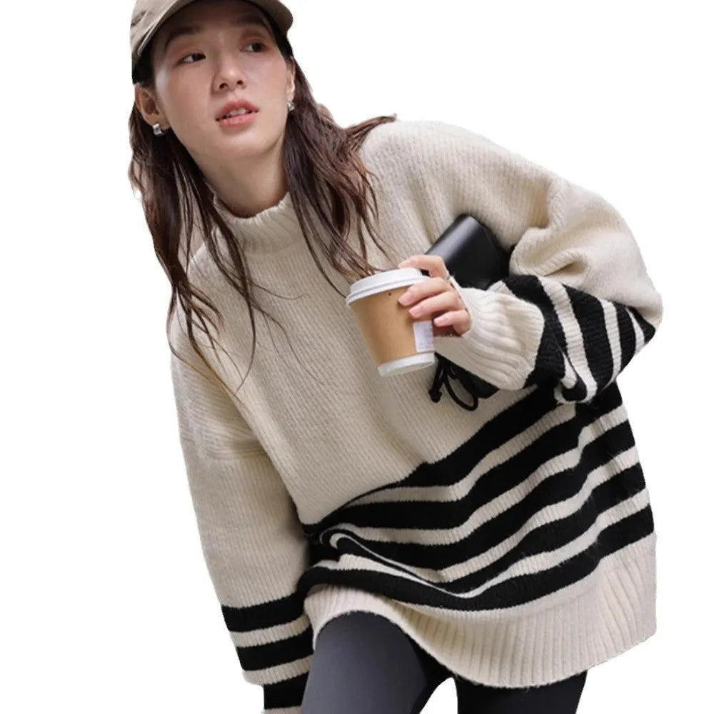Beige winter maternity sweater with stand collar, loose fit, long sleeves, and striped plaid pattern on a woman