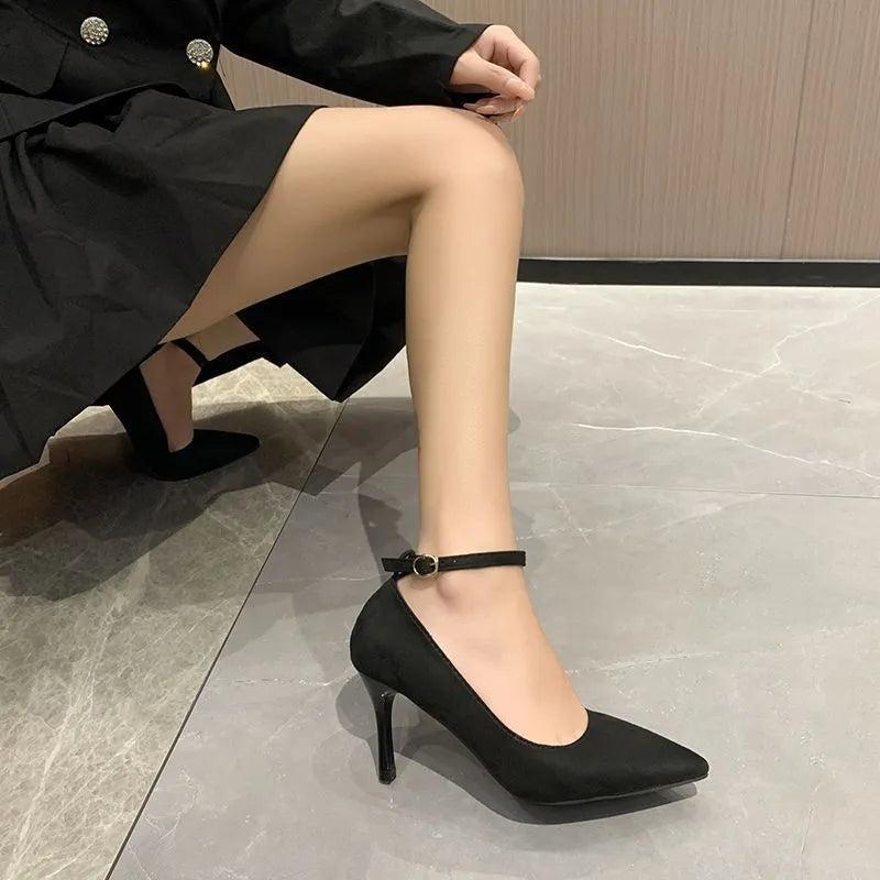 Women's black buckle stiletto pump heel shoe with 8cm heel and rubber sole.