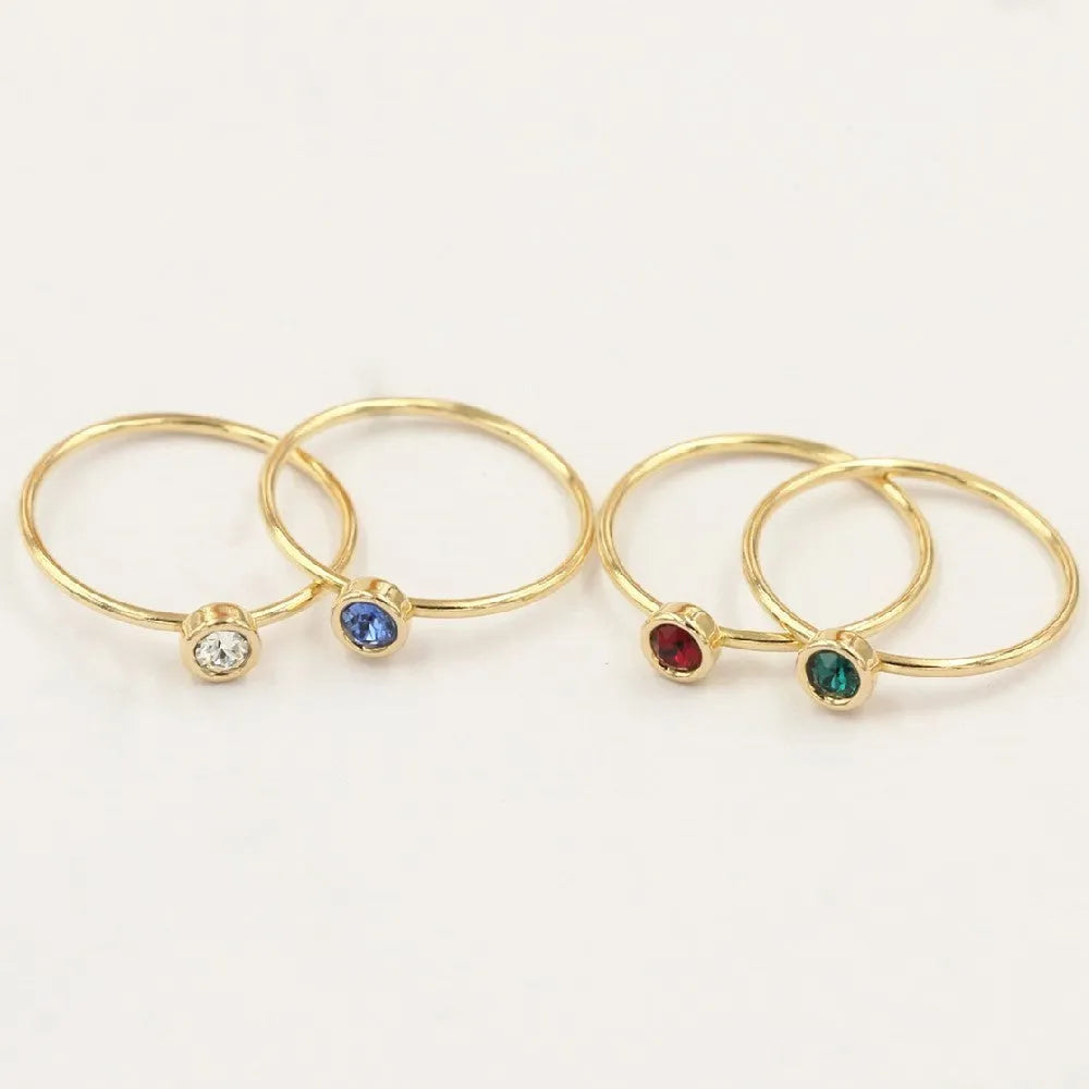 14K gold-plated GF zircon knuckle ring on finger in green colour