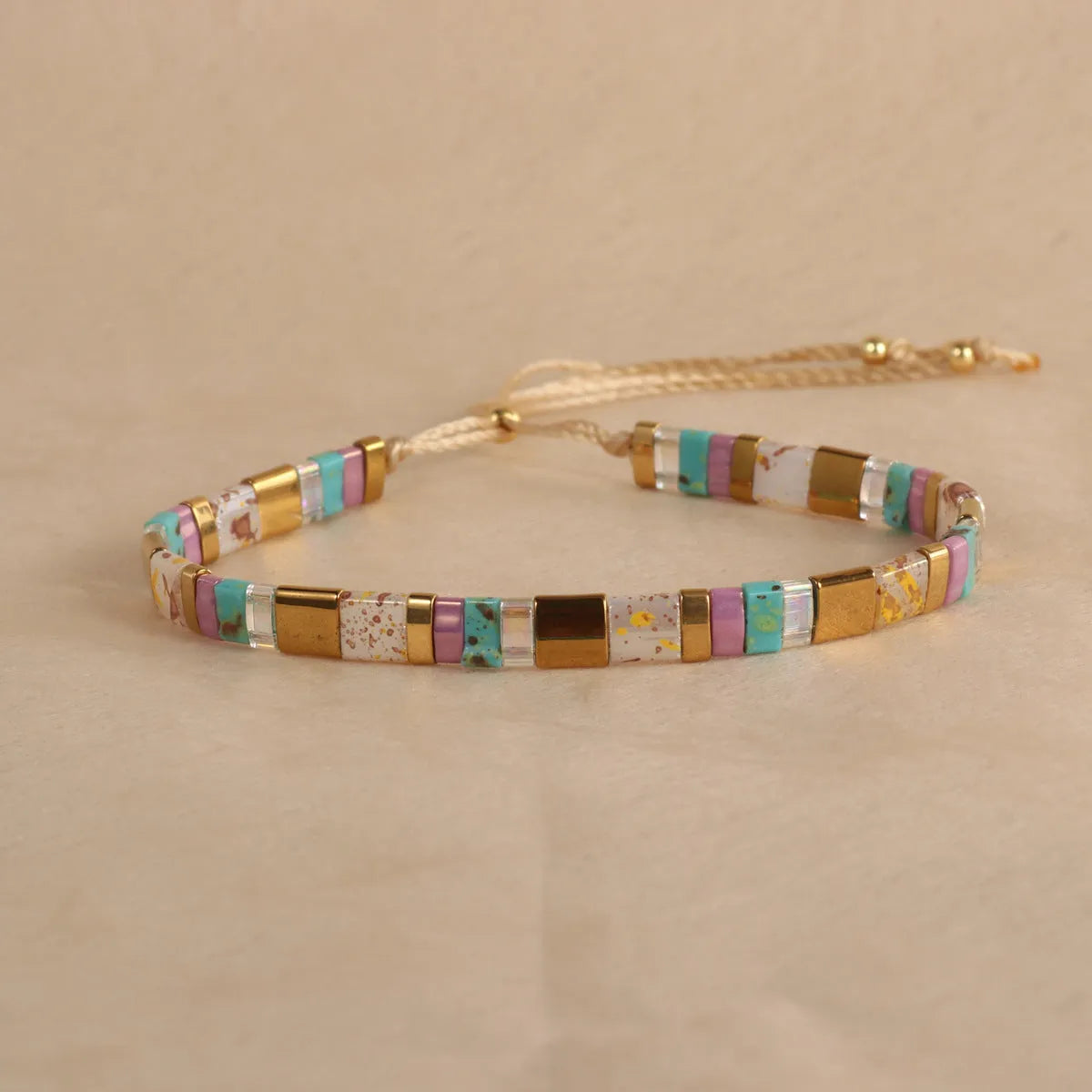 Glass and coloured glaze beaded bracelet with geometric round beads in five colour options