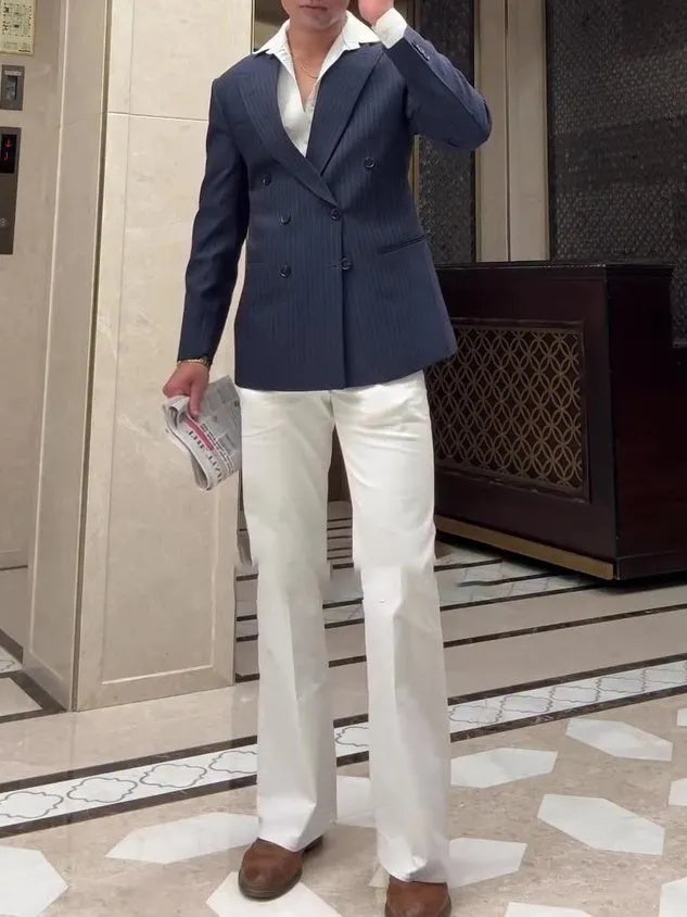 Men's striped double-breasted blazer on a hanger showing regular fit and length