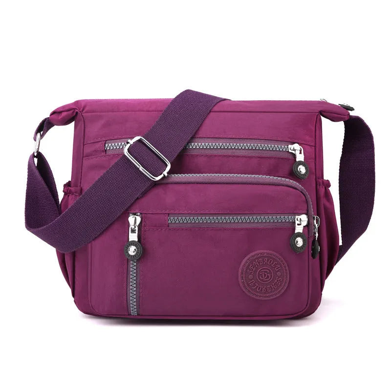 Soft nylon messenger shoulder bag in a choice of five colours including black and blue.