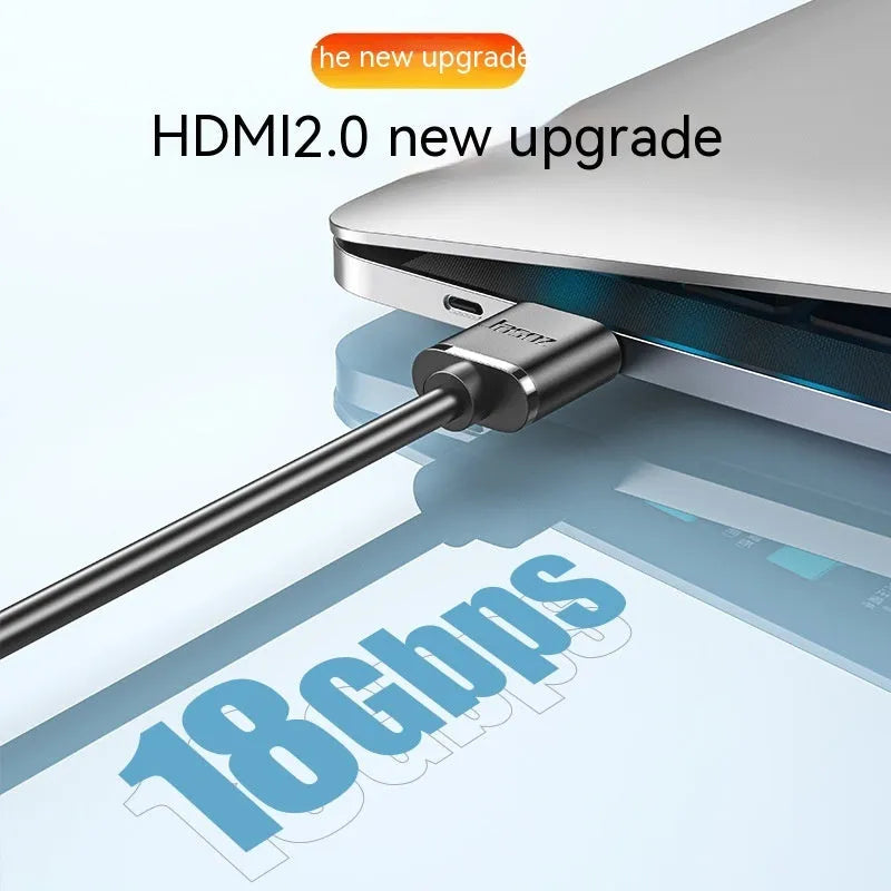Thin flexible HDMI video cable with gold-plated connectors on a white background.