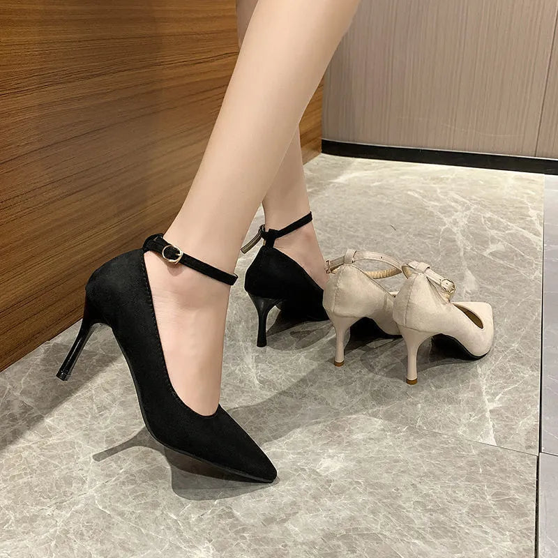 Women's black buckle stiletto pump heel shoe with 8cm heel and rubber sole.
