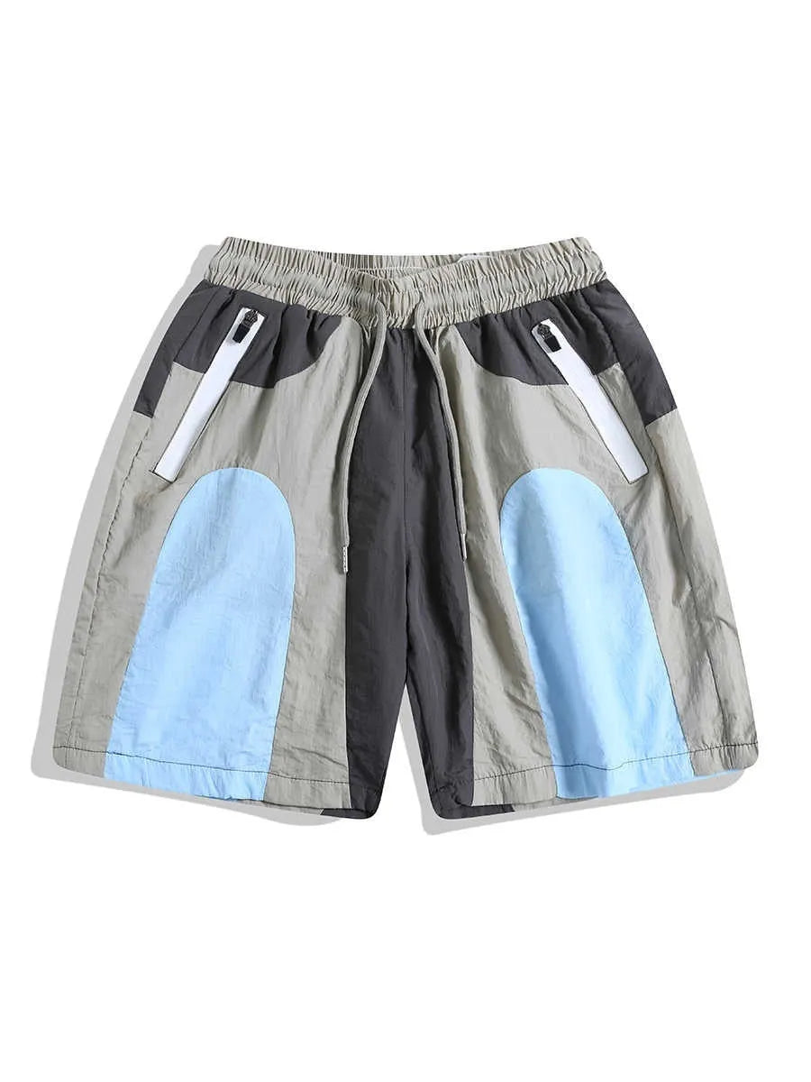 Blue men's loose patchwork quick-drying sports shorts with straight legs and elasticated waist.