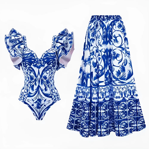 Adult woman modelling a printed one-piece swimsuit in a choice of colours including rose pink, blue, white, and a red apron set style.