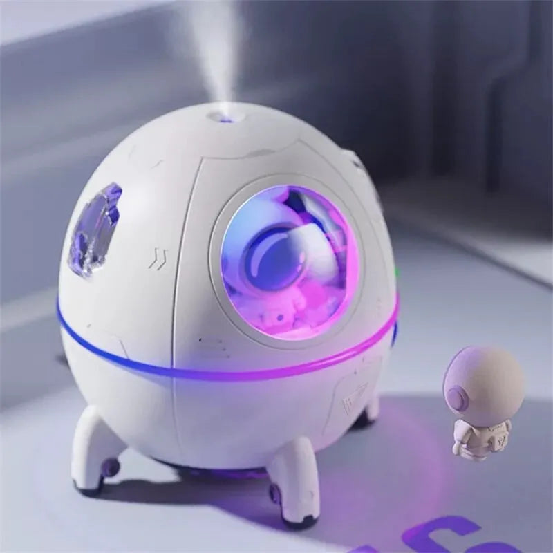 Purple astronaut-shaped USB portable humidifier with LED light on desk