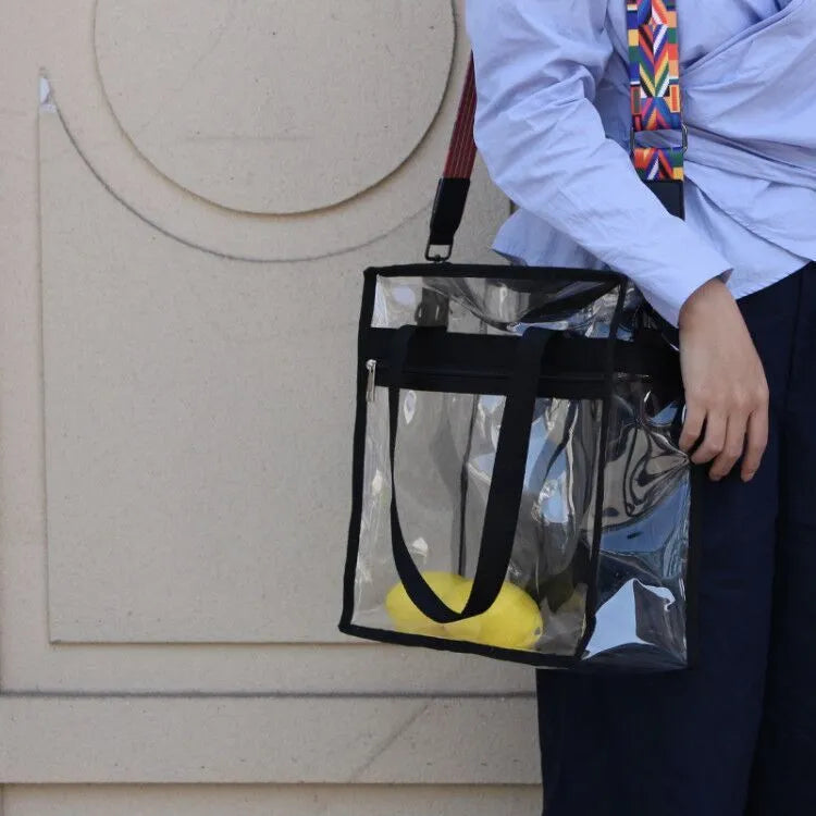 Women's transparent PVC messenger bag with crossbody strap and three-dimensional front pocket.