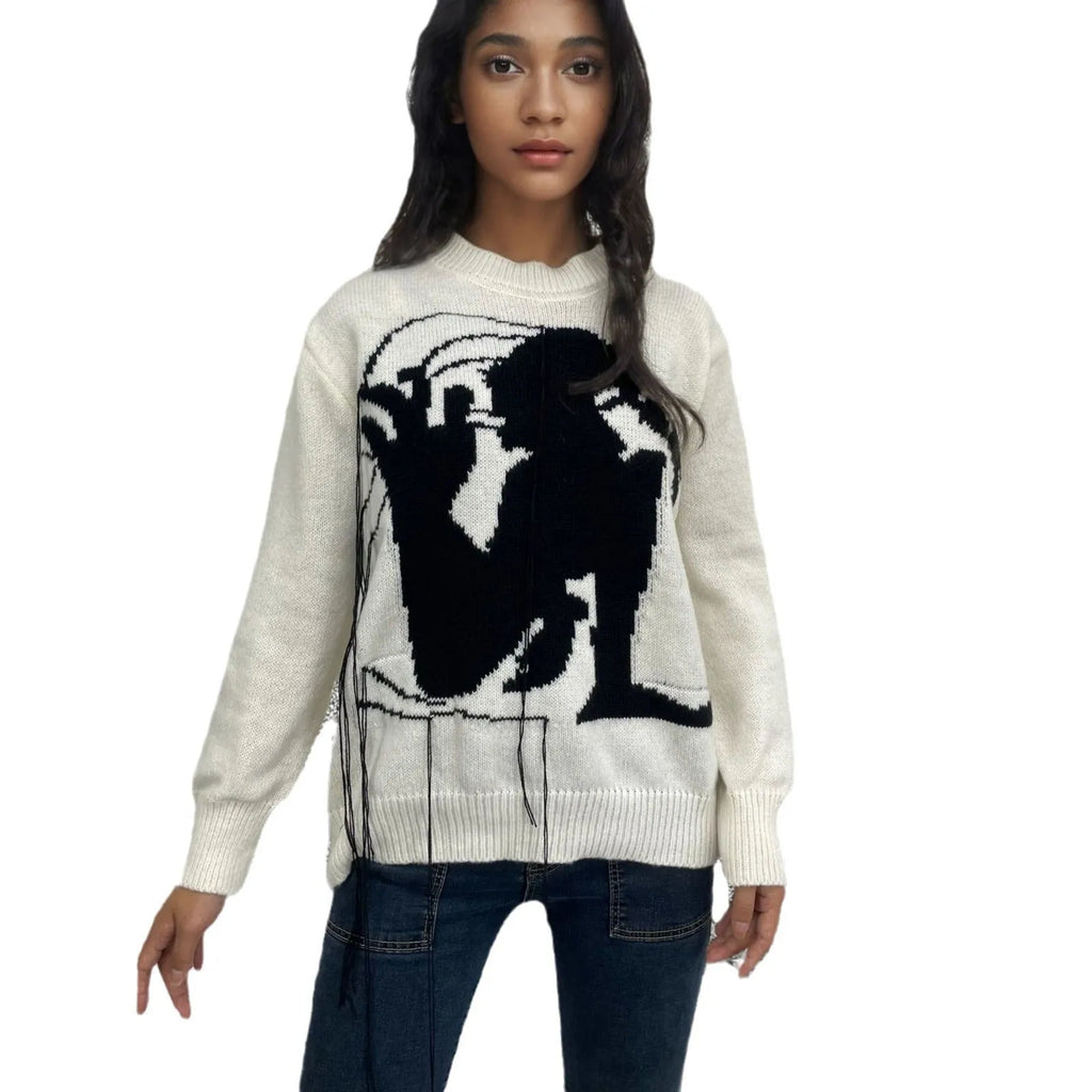 Grey alpaca wool women's sweater with abstract pattern and tassel detail on sleeve.