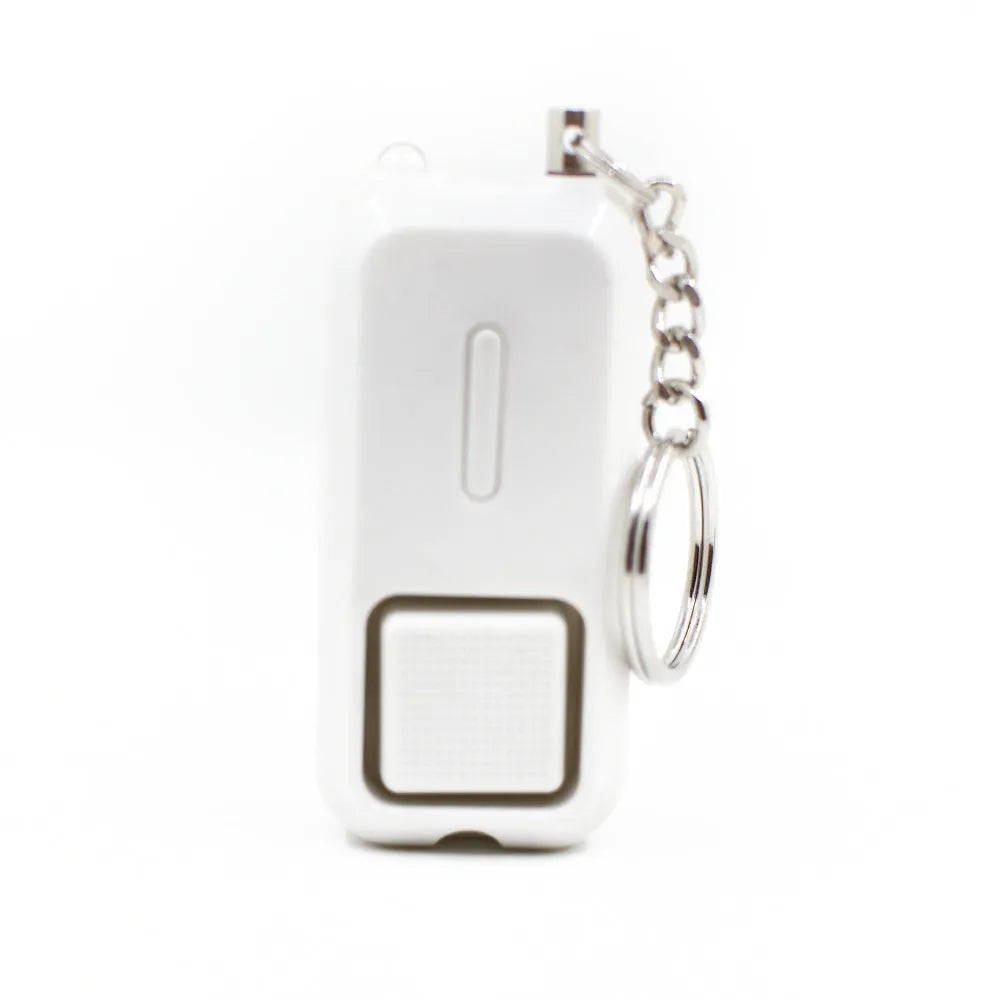 Compact pink personal safety alarm with keyring, showing dimensions next to a ruler.