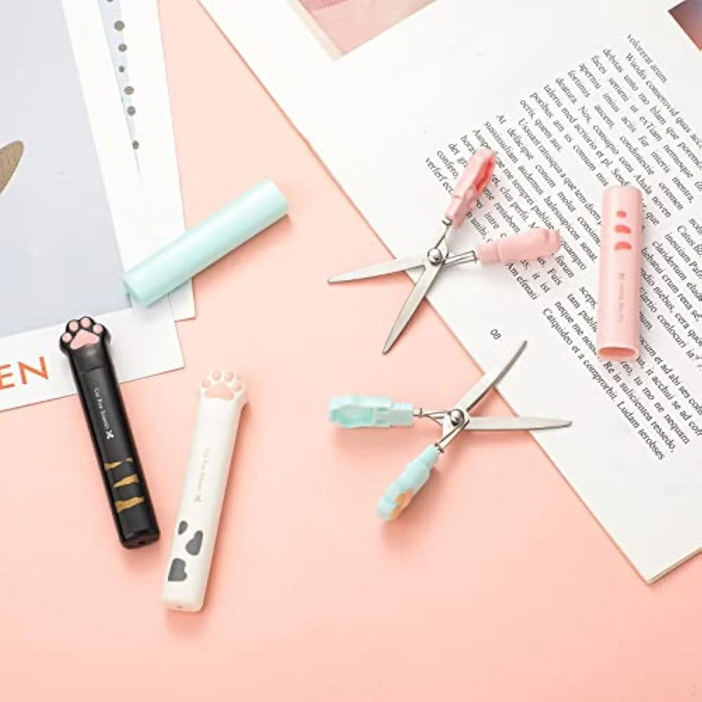 Closed pink cat paw mini folding safety scissors showing the cartoon handle design.