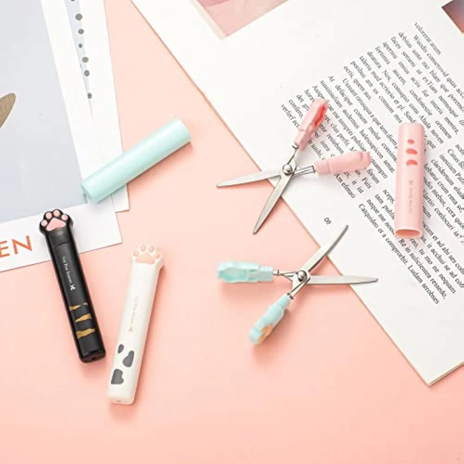 Closed pink cat paw mini folding safety scissors showing the cartoon handle design.