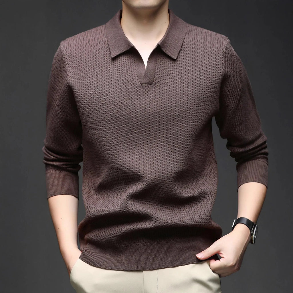 Men's loose green pullover sweater on a hanger, casual autumn wear.