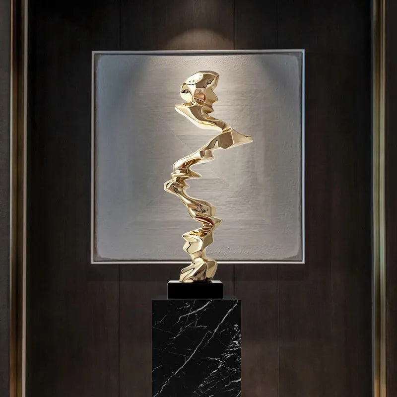 Modern abstract decorative ornament made from natural resin in a choice of gold, silver, or blue.