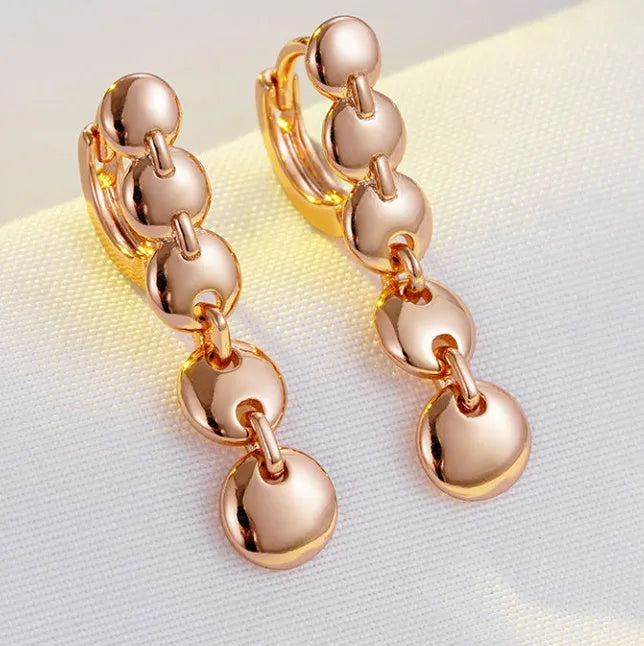 Gold coloured woven copper circle drop earrings with retro design