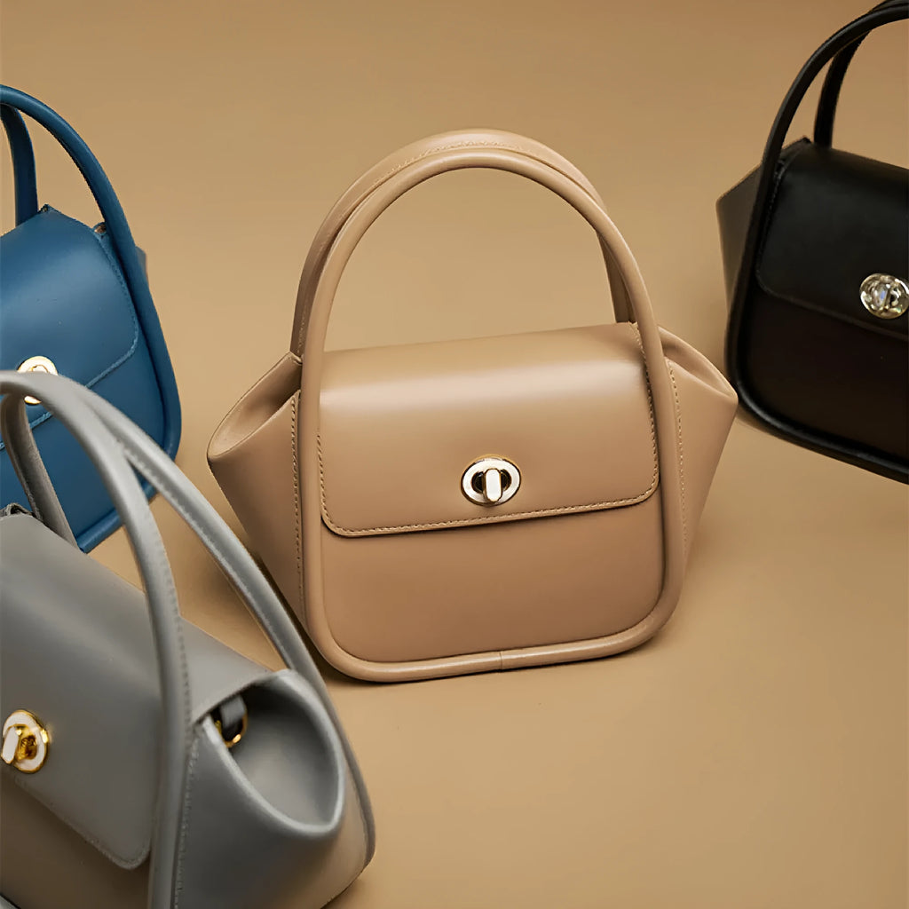 Leather wing bag with latch closure and buckle detailing in cow leather with cross-body strap