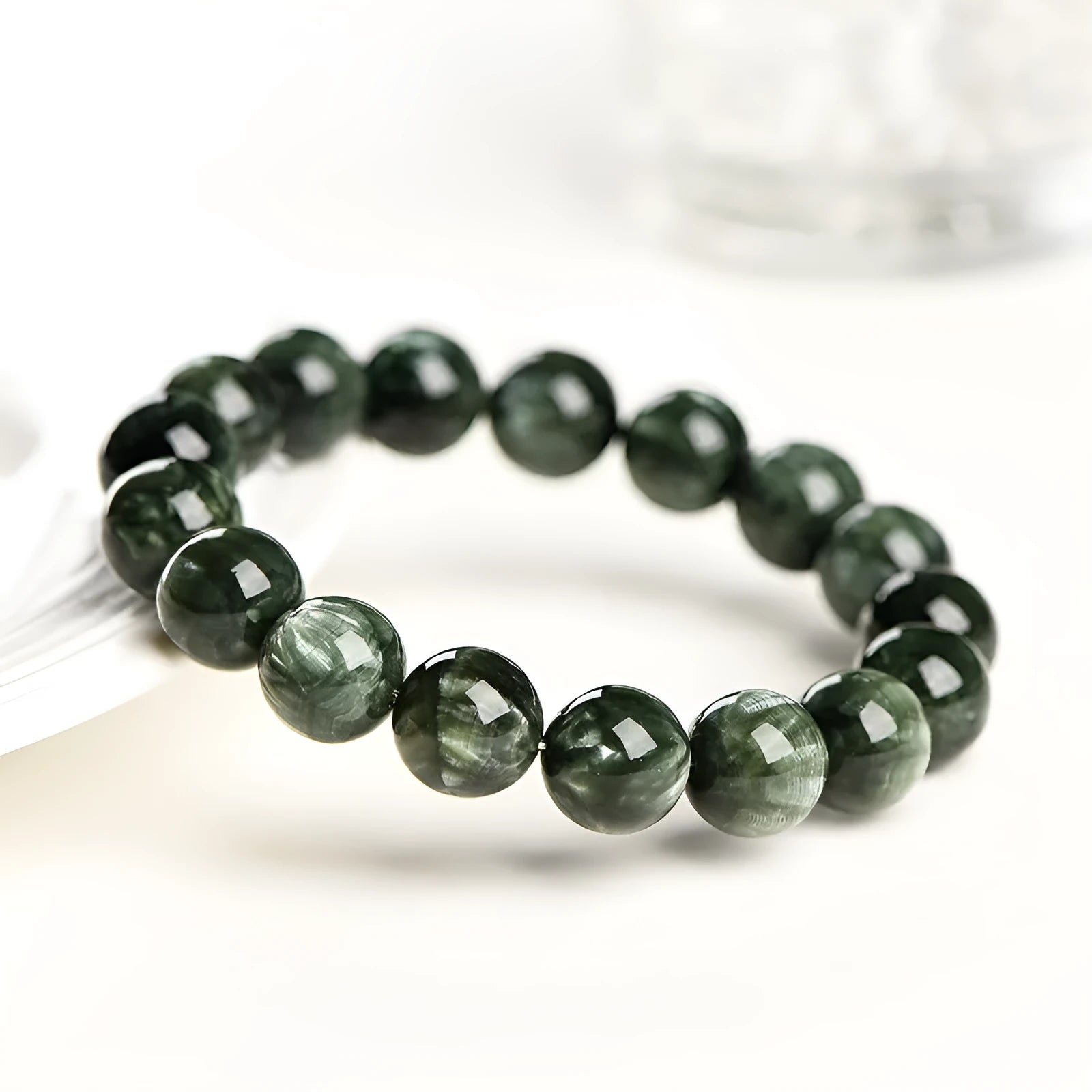 Green Dragon Crystal bracelet with round beads and ruyi design element.