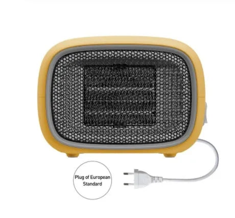 Green, white and yellow mini personal space heater on a desk showing compact size.