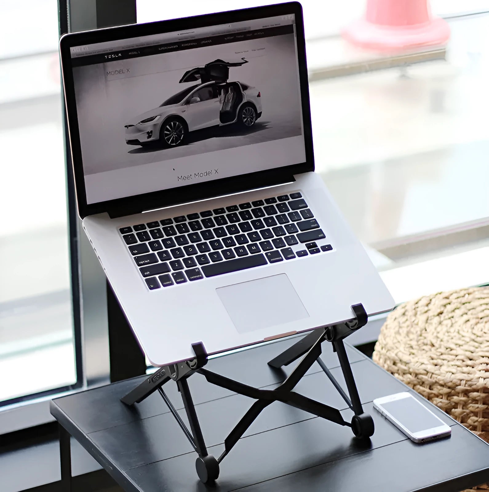 Black folding laptop stand with reinforced nylon construction shown in open and closed positions