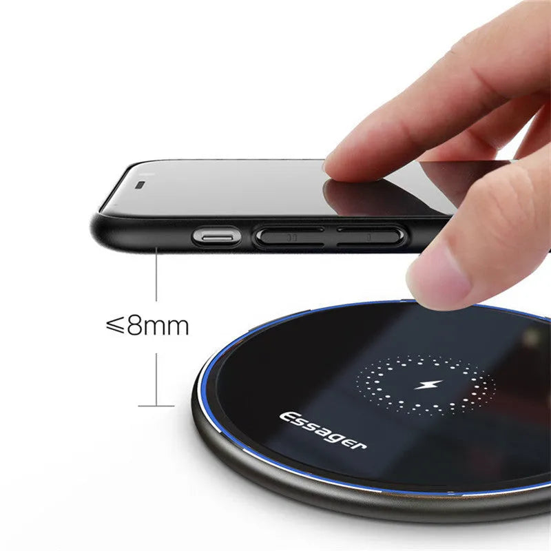 Black or white aluminium alloy 15W Qi wireless charging pad with LED light on a desk.
