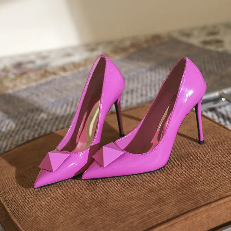 Women's pink pointed toe stiletto high heels with patent leather uppers and ankle buckle detail