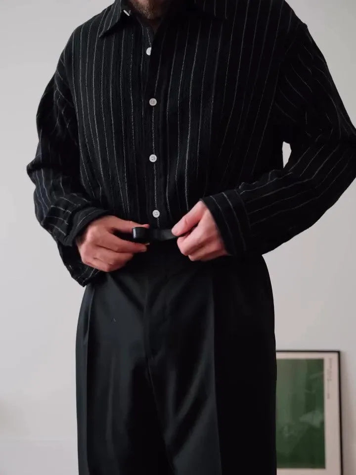 Black pinstriped button-down men's shirt with striped pattern on polyester fabric