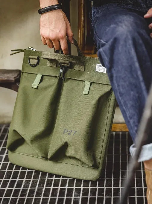 Marden Tooling military green canvas messenger bag with crossbody strap on a table