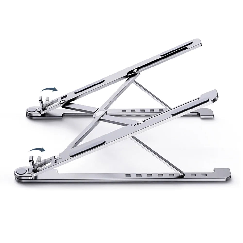 Deep grey portable aluminium laptop stand, folded flat next to an open laptop showing its adjustable height.